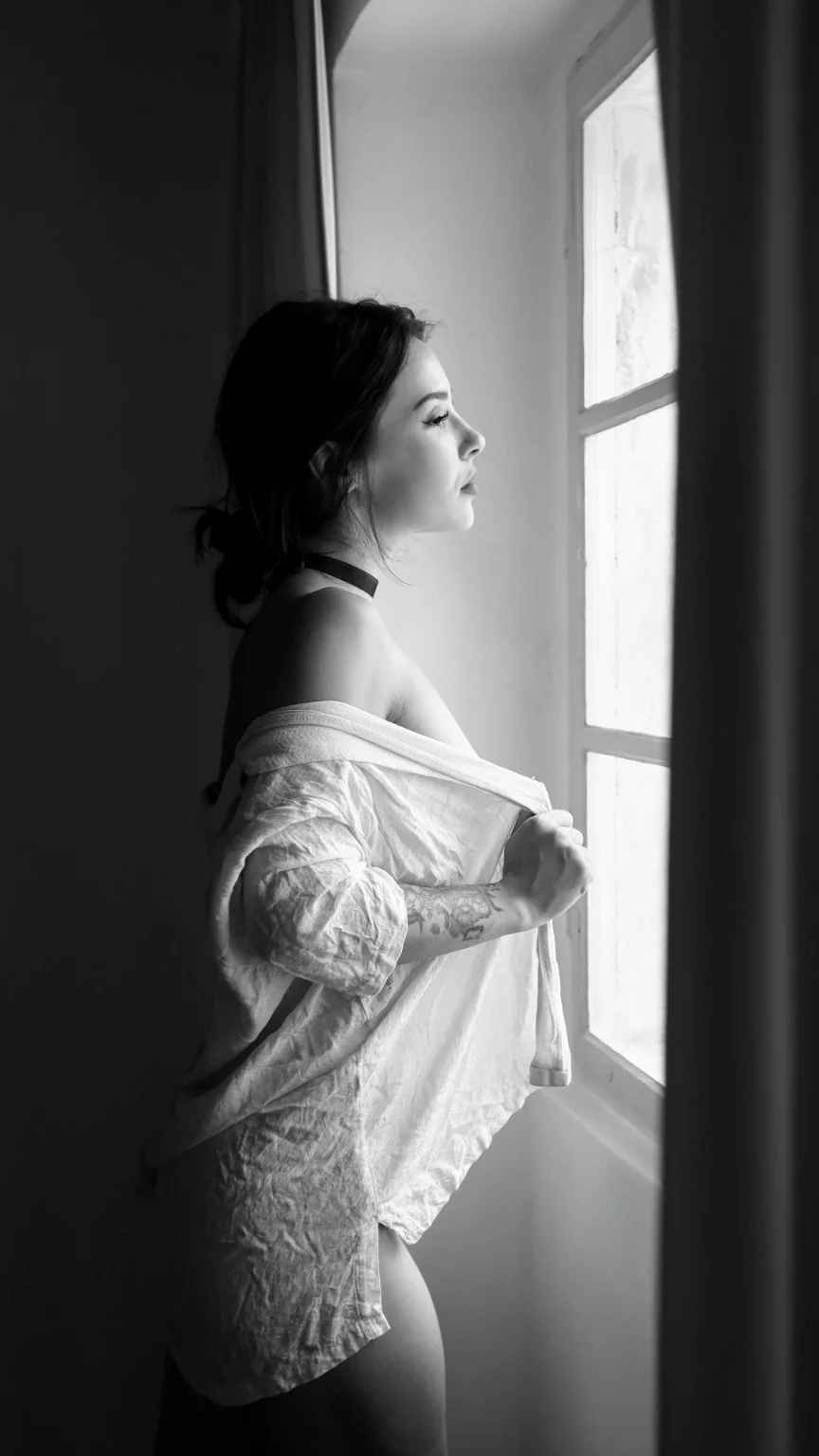 Woman in profile beside a window